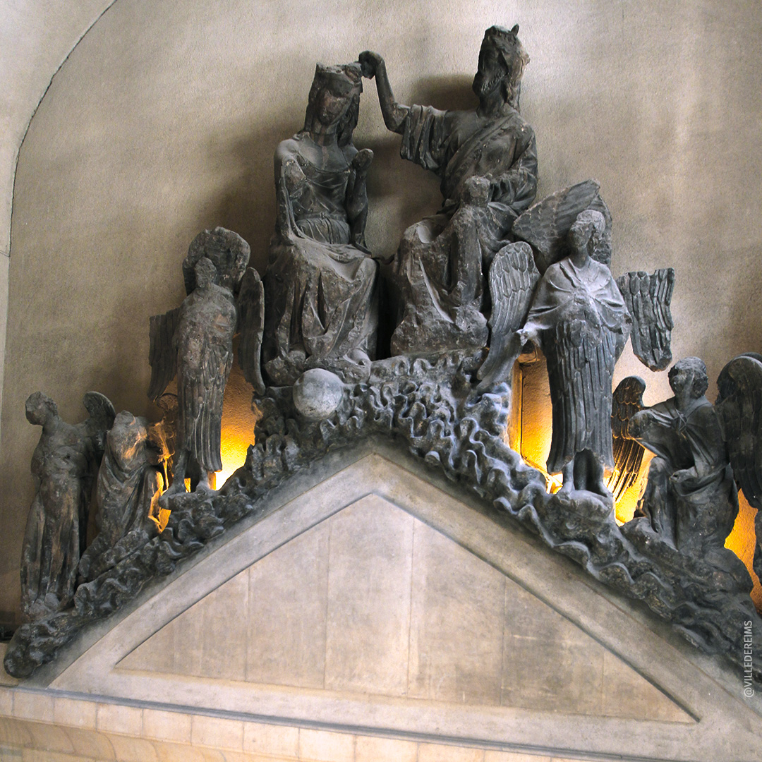 Gâble appelé Couronnement de la Vierge provenant du portail central de la cathédrale. D'une largeur de 8 m et d'une hauteur 5,5 m, il est exposé ici au-dessus de l'escalier d'honneur. ©Ville de Reims